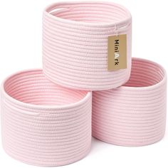 three pink braided baskets with a gold tag on them