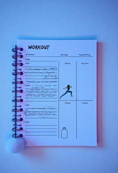 a notebook with workout instructions on the cover and a ball hanging from it's side