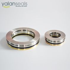 two stainless steel rings sitting next to each other on a white surface with the words valanseals above them