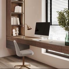 a desk with a computer on it in front of a book shelf and window sill