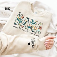 "Custom Nana Sweatshirt, I Wear My Heart On My Sleeve, Gift for Mom, Nana Sweatshirt with Grandkids Name, Personalized Sweater, Grandma Gift Thank you for shopping with us❤️ Size - Our products are unisex fit - You can check our size and color charts on our listing photos. How To Order - Select a size - Select a t-shirt color - If available, indicate the design (text) color in the personalization box - Click add to cart. You can go back to add more shirts. - Click \"Proceed to check out\". Care Instruction -Machine wash in cold water -Do not use bleach -Tumble dry low -Inside out, wash with delicate cycle -Do not iron directly over design Production and Shipping - Processing is 1-3 days * Shipping Time is depending on the shipping option that you choose during to checkout process - Please Sweatshirts For Grandma, Nana Gift Ideas, Quotes Grandma, Nana Sweater, Gift Idea For Grandma, Nana Sweatshirt, Monogram Sweater, Heart On My Sleeve, Grandma Quotes