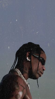 a man with dreadlocks standing in the water