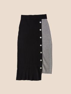 Whether worn for a romantic soirée, a lively happy hour, or a leisurely stroll along the beach, this high-waisted skirt will flow wherever you go. The variation in hem length adds movement and creates drama while an off-center line of decorative buttons add textural play. For a total coordinated ensemble, pair it with our Xyla Top, Sapo Top or Gitana Cardi. TWO-TONE PENCIL SKIRT IN MULTI-RIB PATTERN AND ACCENT MOP BUTTONS AT TIERED BELOW KNEE LENGTH Ray is 5'11” wearing a size S/M Available size Black Pleated Maxi Skirt For Day Out, Elegant Black Skirt For Day Out, Black Asymmetrical Skirt For Day Out, Chic Black Asymmetrical Skirt, Elegant Black Maxi Skirt For Day Out, Chic Black Asymmetrical Maxi Skirt, Chic Black Midi Skirt, Mop Buttons, Center Line