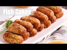 fish cakes on a white plate with oranges in the background and text overlay