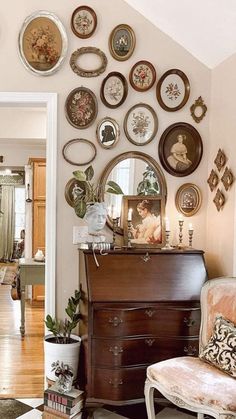 a living room filled with furniture and lots of plates on the wall