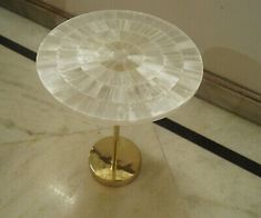 a white table with a gold plate on it