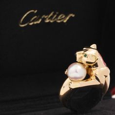 Tres chic ring from Cartier from their Vedra collection, now discontinued and highly collectible. The ring showcases their iconic panther, clutching a pearl. A wonderful juxtaposition showcasing power and femineity at the same time. 18kt yellow gold Stamped Cartier and numbered Size 52 (fits like a size 6) Will come with paperwork from Cartier New York where the ring was recently sent for refurbishment. Please see qualitative report for more information. Video Below Luxury Pearl Ring For Evening, Modern Mens Rings, Art Jewelry Earrings, Chic Rings, All Band, Antique Watches, Antique Engagement, Mens Band, Tres Chic