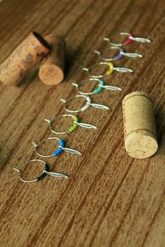 wine corks are lined up on the table to be used as earring holders