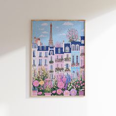 a painting is hanging on the wall next to a vase with flowers in front of it