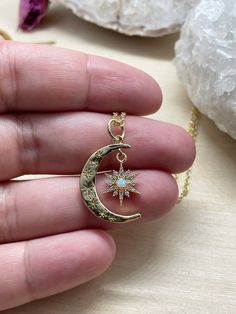 "This listing is for one gold crescent moon and star necklace. It has tiny cubic zirconia stones, and a man made opal inside it. This gorgeous statement piece hangs from a tarnish resistant gold chain. Your necklace will be stored in a hand stamped Kraft jewelry box, wrapped in bubble wrap, and mailed via USPS. If you spend over $35, domestic shipping is free! - \"All shadows of clouds the sun cannot hide like the moon cannot stop oceanic tide; but a hidden star can still be smiling at night's b Celestial Crescent Gemstone Jewelry, Mystical Star-shaped Jewelry Gift, Celestial Moon Charm Pendant Jewelry, Celestial Jewelry With Star Charm For Gifts, Celestial Style Moon Charm Pendant Jewelry, Celestial Style Star Charm Jewelry For Gifts, Celestial Star Jewelry For Jewelry Making, Celestial Star-shaped Gemstone Jewelry, Star-shaped Opal Jewelry Gift