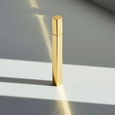 a golden object is sitting on the floor with light coming from it's side