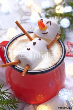 hot chocolate with marshmallows and snowman on top in a red mug