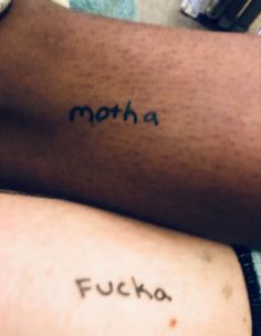 two people with tattoos on their arms that say, motha and fuckoo