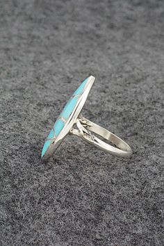 This turquoise and sterling silver inlay ring was made by Zuni silversmith Orena Leekya. The back is signed O. Leekya and Zuni.Size: 7.5Length: 1"Width: 1/2"Free shipping on all orders! We ship with USPS and always include tracking. All orders ship within a day of payment.Returns are accepted up to 30 days after you receive your order. Just send us a message. Our shop offers cash back or store credit. The item must be returned in new condition. Turquoise Sterling Silver Rings With Polished Finish, Oval Turquoise Rings With Inlay, Adjustable Oval Turquoise Ring With Inlay, Oval Turquoise Inlay Rings, Turquoise Inlay Ring As A Gift, Turquoise Opal Ring In Sterling Silver, Turquoise Inlay Ring As Gift, Oval Turquoise Ring With Sterling Silver Inlay, Silver Turquoise Ring With Inlay For Gift