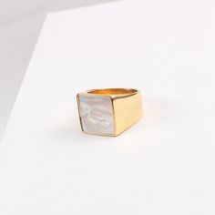 This 18K Gold Plated Large Square Mother-of-Pearl Ring is a luxurious, statement-making piece. Featuring a chunky gold band with both mother-of-pearl and black onyx accents, it's the perfect unique gift for any special occasion. This signet ring is also an ideal stacking ring for daily wear. [MATERIAL]: Yellow brass with real 18k gold plated. Our ring will not tarnish or turn green.[PLEASE NOTE]: Each shell color is unique so the shade and color might slightly vary. Elegant Gold Rings With Mother Of Pearl, Gold Mother Of Pearl Ring For Gift, Gold Mother Of Pearl Rings For Anniversary, Gold Mother Of Pearl Anniversary Rings, Gold Mother Of Pearl Ring As A Gift, Modern Gold Jewelry With Mother Of Pearl, Mother Of Pearl Ring, Clean Sterling Silver, Shell Color