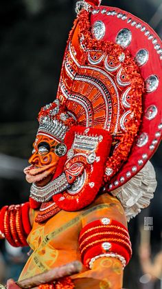 a person in an orange and red costume