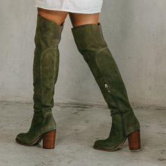 Our best-selling thigh-high boot will elevate any ensemble. The Logan olive over-the-knee boot features a soft, unlined suede upper, an easy to wear heel height, and an elastic back panel at the calf for added comfort. Suede upper in olive Insole: Canvas Lining material: Vamp, canvas and shaft unlined Outsole: Recycled rubber Style type: Over the knee boot Heel material: Stacked Heel height: 3.15 inches Shaft height: 20 inches Calf circumference: 14 inches Brass functional inside zipper Elastic Tall Ugg Boots Outfit, Brown Suede Boots Outfit, Green Thigh High Boots, Suede Boots Outfit, Womens Fall Boots, Creative Fashion Photography, Work Fits, Brown Knee High Boots, Suede Boots Knee High