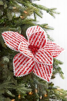 an ornament hanging from the top of a christmas tree