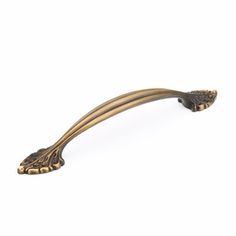 an antique brass door handle on a white background