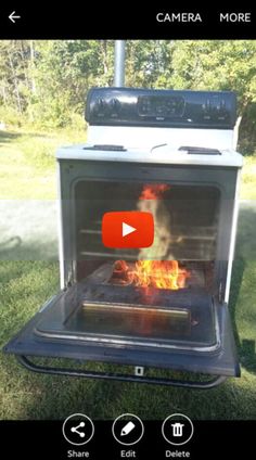 an open oven with flames in it on the grass