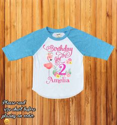 "Flamingo birthday shirt, flamingo family shirts, birthday girl flamingo shirt, first birthday outfit, baby girl birthday, baby girl H234 Wellcome to happy kid Customs!! : ) Please read all info before placing your order : ) This Design IS NOT MADE with glitter. -This listing is for a 3/4 colored sleeve/white body OR White short sleeve personalized shirt, we carry different sizes. ( Please make sure to select the same type of shirt you are purchasing on both drop down menus if you select a short Pink Summer Tops With Name Print, Pink Birthday Shirt For Summer, Pink Summer Birthday Shirt, Long Sleeve Summer Tops For Birthday, Personalized Pink Tops For First Birthday, Personalized Pink Top For First Birthday, Custom Pink Tops For First Birthday, Pink Summer Tops For Birthday, Long Sleeve Summer Shirt For Birthday