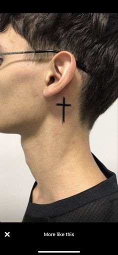 a man with a cross tattoo on his neck