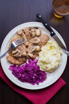 a white plate topped with meat, mashed potatoes and veggies