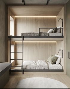 two bunk beds in a room with wooden walls and flooring, along with a round rug on the floor