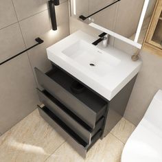 a white sink sitting next to a toilet in a bathroom on top of a tiled floor