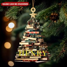 a christmas tree made out of books with the words henry hanging from it's top