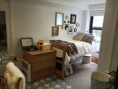 a bed room with a neatly made bed and desk