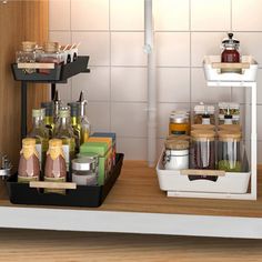 a kitchen counter with spices and condiments on the shelf next to each other