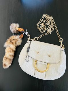 White ostrich Gucci Smilla handbag with gold-tone hardware, 20" chain, and removable raccoon fur tails featuring bamboo accents. One interior compartment with pocket and snap closure at top.  Made in Italy and originally sold for $3000. White Gucci Shoulder Bag With Chain Strap, White Gucci Bag With Detachable Handle, Gucci Fur Bags For Women, Ostrich Handbags, Gucci Leather Bags With Gold-tone Hardware, Gucci Bag With Gold-tone Hardware And Top Handle, Racoon, Clutch Handbag, Purses And Handbags