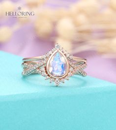 a close up of a ring with an opal in the center and diamonds around it