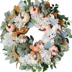 a wreath with white flowers and pumpkins on it is displayed in front of a white background