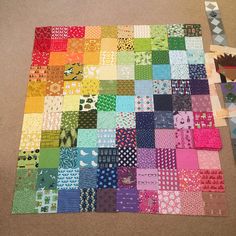 a patchwork quilt is laid out on the floor