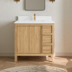 a bathroom vanity with a mirror above it and a rug on the floor next to it