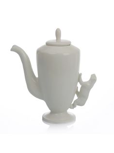 a white ceramic teapot with a lid