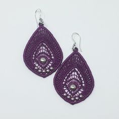 pair of purple earrings with silver beads on white background