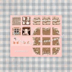 a pink and blue checkered table cloth with pictures of farm animals on it's sides