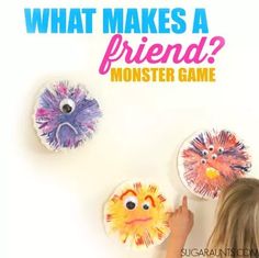 a girl pointing at two paper plates with faces on them and the words, what makes a friend? monster game