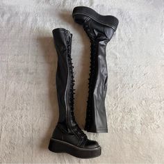 Good Used Condition. Emily 375 Thigh-High Boots By Demonia In Black. Goth Punk Club Aesthetic. Chunky Platform Flatform Lace-Up Boots Made From Black Stretch Vegan Leather, See Video. Over-The-Knee Silhouette. Side Zipper For Easy On/Off. Note: Light Wear With Streetwear To Bottom Sole, Scuffing At Bottom Heel And Outsole, Heel Drag, And A Few Minor Surface Marks, See Photos. Size 6, See Photos For Measurements. Goth Boots Aesthetic, Alternative Black Knee-high Platform Boots, Black Knee-high Platform Boots For Alternative Fashion, Black Lace-up Knee-high Platform Boots, Rick Owens Boots, Black Knee-high Grunge Platform Boots, Gothic Platform Knee-high Boots For Alternative Fashion, Demonia Boots, Goth Boots