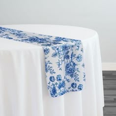 a white table with blue flowers on it