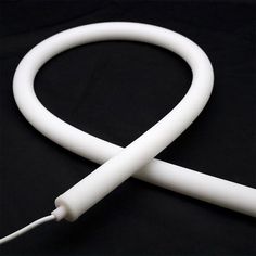 the white cord is plugged in to an iphone charger on a black surface