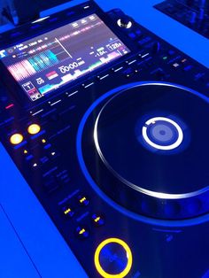 a dj turntable sitting on top of a blue table