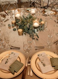 the table is set with silverware and place settings