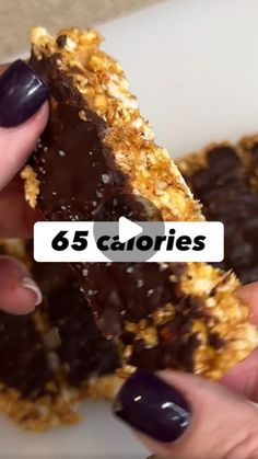 a person is holding some kind of chocolate covered cookie with the words 65 calories on it