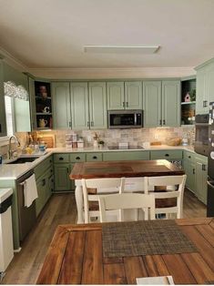 a kitchen with wooden floors and green cabinets