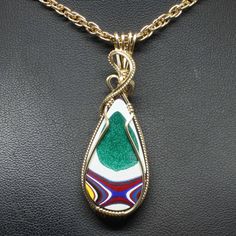 "Fordite Wire Wrapped Jewelry Description:  *Designer Fordite Detroit Agate Cabochon: 35mm x 20mm Teardrop Shaped *Pendant Approximate Size: 2 1/4\" long including bail x 3/4\" at widest point  *Free Rope Chain *Free Domestic Shipping - Arrives in Gift Box - Gift Wrapping Available The contemporary wire wrap jewelry is hand wire sculptured using 14k gold-filled wire around the recycled Fordite Detroit Agate cabochon to form this collector's item handmade wire wrap pendant statement necklace. The bail is large enough to accommodate various style chains. Each Fordite wire wrapped pendant is handmade by me from inception to finished product. They are not mass produced nor manufactured. This is the exact pendant you will receive when purchased. Fordite or Detroit Agate is a recycling of the en Gold Teardrop Agate Jewelry, Fordite Jewelry, Wire Wrapped Bracelet, Agate Cabochon, Wrap Jewelry, Gold Bracelet For Women, Handmade Wire Wrapped, Gold Bangle Bracelet, Silver Bangle Bracelets