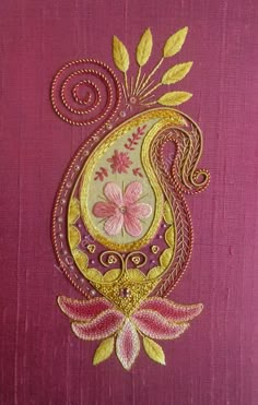 an embroidered design on pink fabric